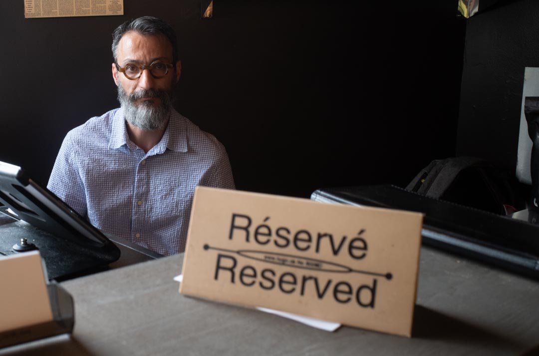 Arash, owner of Toucheh Restaurant, at a reserved table